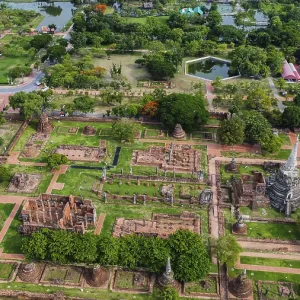An ancient temple complex next to a city and a modern temple An ancient temple complex next to a city and a modern temple