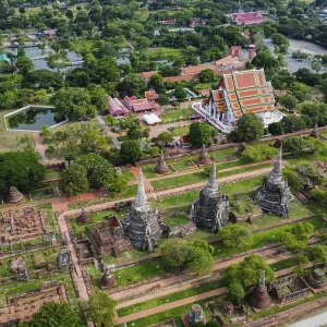 An ancient temple complex next to a city and a modern temple An ancient temple complex next to a city and a modern temple