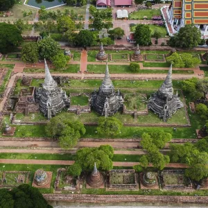 An ancient temple complex next to a city and a modern temple An ancient temple complex next to a city and a modern temple