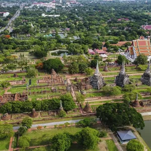 An ancient temple complex next to a city and a modern temple An ancient temple complex next to a city and a modern temple