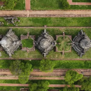 An ancient temple complex next to a city and a modern temple An ancient temple complex next to a city and a modern temple
