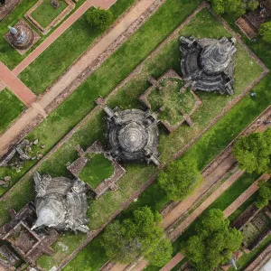 An ancient temple complex next to a city and a modern temple An ancient temple complex next to a city and a modern temple