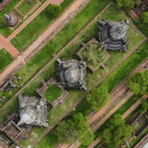 An ancient temple complex next to a city and a modern temple An ancient temple complex next to a city and a modern temple