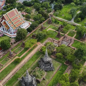 An ancient temple complex next to a city and a modern temple An ancient temple complex next to a city and a modern temple