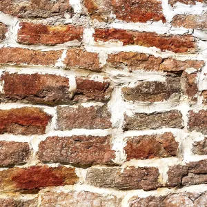 Ancient weathered rough stone wall as creative background Ancient weathered rough stone wall as creative background