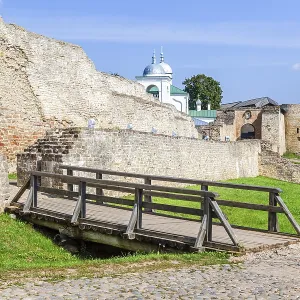 Ancient weathered rough stone walls and tower of the Izborsk fortress Ancient weathered rough stone walls and tower of the Izborsk fortress