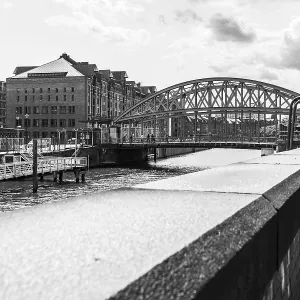 Arch bridge and historic brick warehouses in Hamburg's Speicherstadt<br> Arch bridge Arch bridge and historic brick warehouses in Hamburg's Speicherstadt<br> Arch bridge