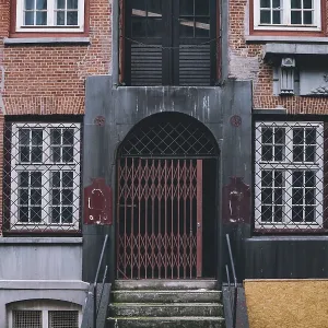 Architectural detail of an aged brick facade and secured Architectural detail of an aged brick facade and secured