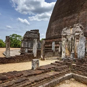 Architectural details and ruins of an ancient site next to a large stupa Architectural details and ruins of an ancient site next to a large stupa