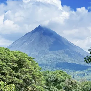 Arenal volcano behind tropical forest Arenal volcano behind tropical forest