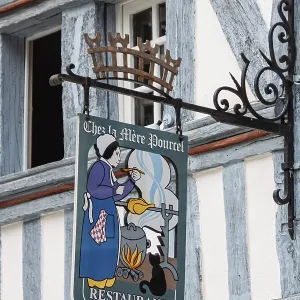 Artfully decorated restaurant sign on a traditional half-timbered house