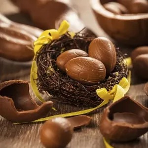 Assorted chocolate eggs for Easter on wooden background