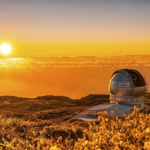 Astronomical Observatory of the Caldera de Taburiente in a beautiful orange sunset with the sun above