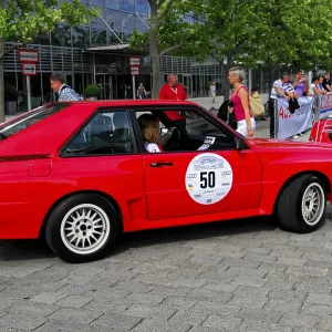 AUDI Sport Quattro, red Audi classic car with stickers at a rally on a city street