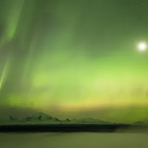 Aurora and the moon over the fog shrouded Copper River