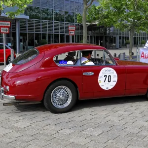 Austin Martin DB 2-4, side view of a red classic car on cobblestones at a car event