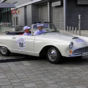 Auto Union 1000 SP, white vintage convertible in the foreground with modern architecture