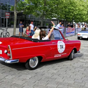 Auto Union F 12 Roadster, rear view of a red vintage convertible with people in an urban environment
