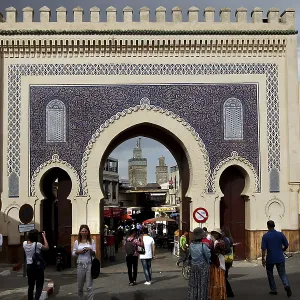 Bab Boujeloud in Fez with traditional mosaics and numerous passers-by