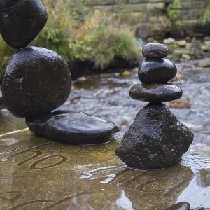 Balanced stones stack next to a stream