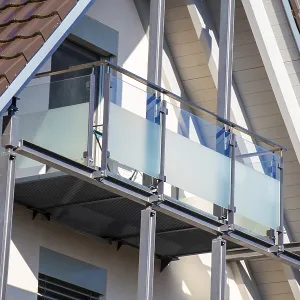 Balcony railing made of glass and stainless steel on a residential building