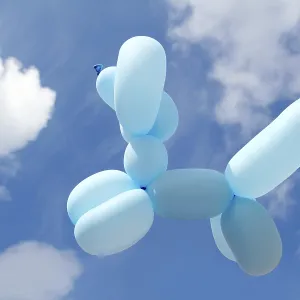 Ballon with poodle dog caniche shape flying in blue sky sunny day Ballon with poodle dog caniche shape flying in blue sky sunny day