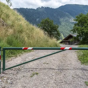 Barrier on gravel path in rural mountain region