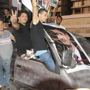 Bashir supporters loyal to Syria's regime drive away from the Beirutur Corniche