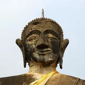 Battered buddha statue of the Wat Phia Wat Temple