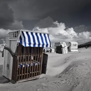 Beach chairs, dramatic clouds in the sky