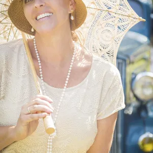 Beautiful 1920s dressed girl with parasol near vintage car portrait Beautiful 1920s dressed girl with parasol near vintage car portrait