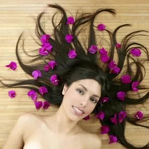 Beautiful indian woman portrait in a beauty spa with bougainvillea flowers Beautiful indian woman portrait in a beauty spa with bougainvillea flowers