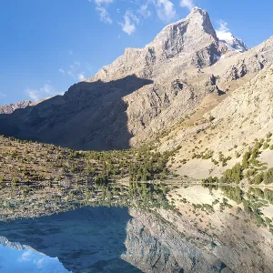 The beautiful mountain trekking road with clear blue sky and rocky hills