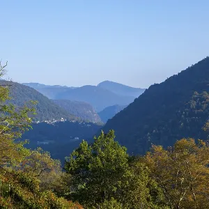 Beautiful Panoramic View over Mountain Range and Valley with Vineyard and with Sunlight Beautiful Panoramic View over Mountain Range and Valley with Vineyard and with Sunlight