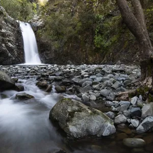 Beautiful Waterfall with stones on the ground in the heart of Machairas forest at Troodos mountains in Cyprus Beautiful Waterfall with stones on the ground in the heart of Machairas forest at Troodos mountains in Cyprus