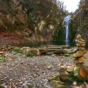Beauty autumn view on a waterfall jump near the village Kaleytsa near Troyan and several zen stone