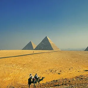 Bedouins on camels, Pyramids of Giza in the back Bedouins on camels, Pyramids of Giza in the back