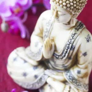 Buddha Figurine with Orchids on Red Background Print
