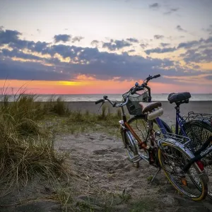 Bicycles parked on Amager beach at sunrise