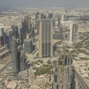 Bird's eye view of urban skyline with futuristic skyscrapers under clear sky