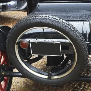 Black retro car back side, spare wheel closeup Black retro car back side, spare wheel closeup