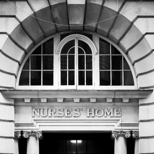 Black and white image of an arched window above the entrance to a historic building in Greater London Black and white image of an arched window above the entrance to a historic building in Greater London