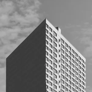 Black and White Skyscraper on the Cloudy Sky Background Black and White Skyscraper on the Cloudy Sky Background