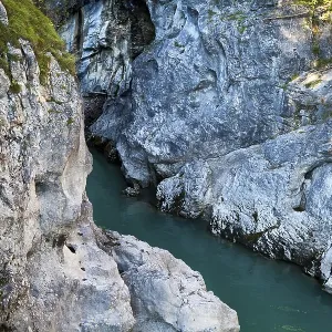 Blue alpine river between two cliffs
