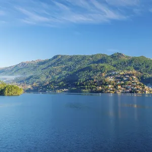 Blue Cavado River and Green Mountains on Sunny Day