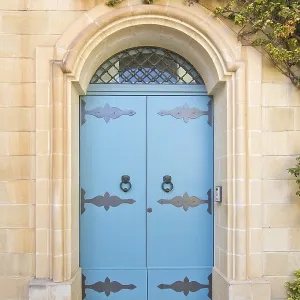Blue door with iron knobs. Painted doors of Malta series Blue door with iron knobs. Painted doors of Malta series