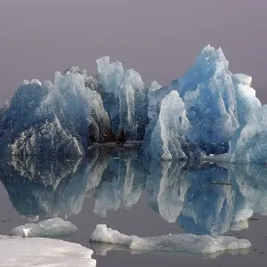 Blue iceberg reflected in the water Blue iceberg reflected in the water