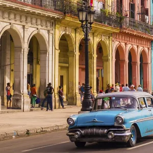 A blue oldtimer taxi is driving through Habana Vieja in front of a colorful facade A blue oldtimer taxi is driving through Habana Vieja in front of a colorful facade