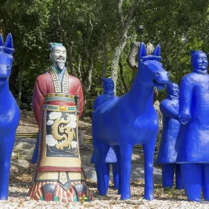Blue terracotta soldiers and horse statues with a painted soldier in a forest Blue terracotta soldiers and horse statues with a painted soldier in a forest