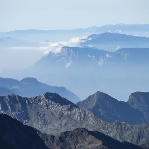 Blurred mountains in fog against a clear blue sky offer tranquil views